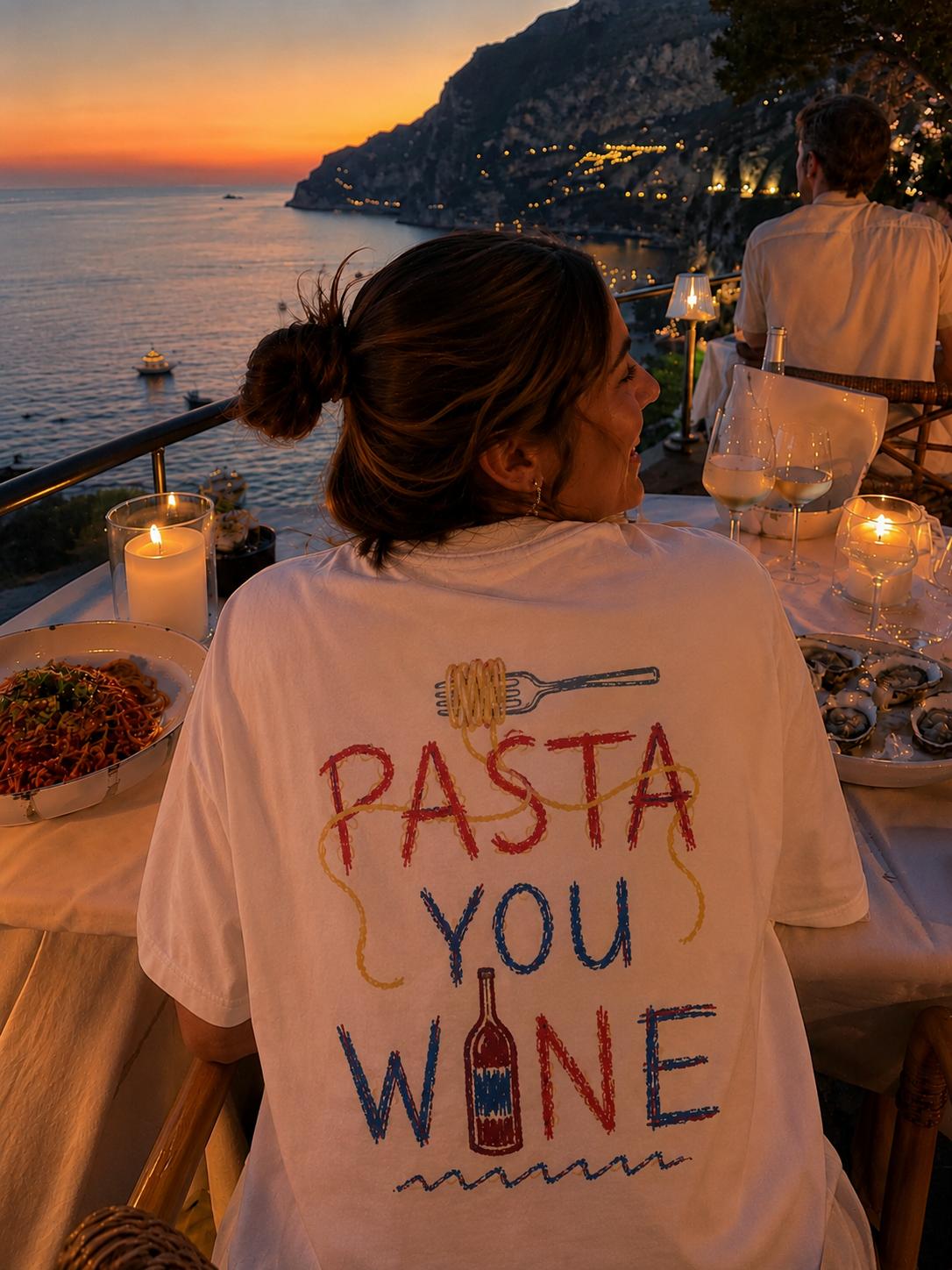A candlelit dinner table above the sea at golden hour